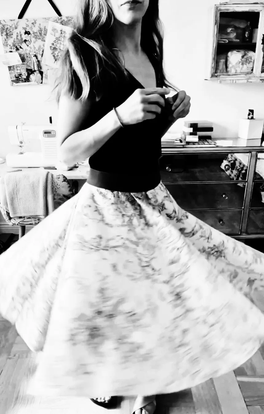 Chancel Studio founder wearing a handmade circle skirt in her sewing workspace.