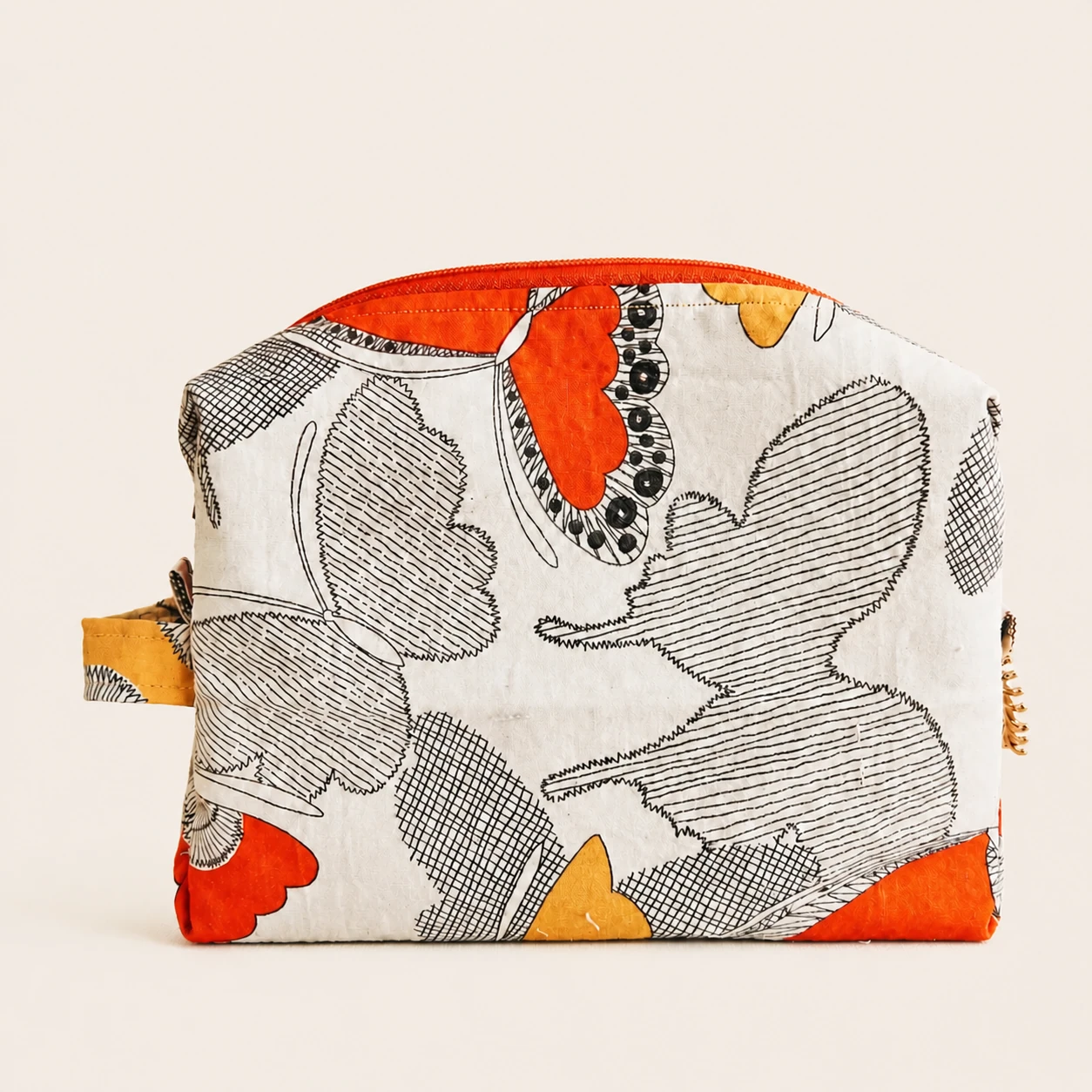Front view of the Butterfly Pouch in cream, black, orange and mustard printed cotton.