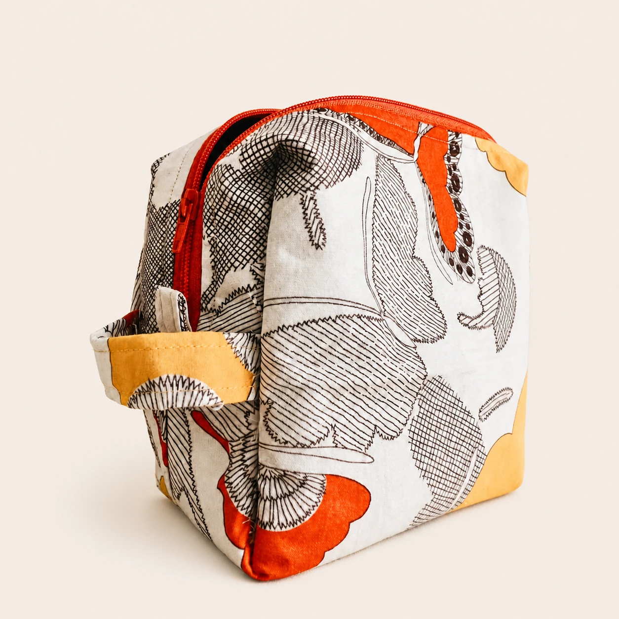 Reverse three-quarter view of the Butterfly Pouch showing its orange zipper and textile side handle.