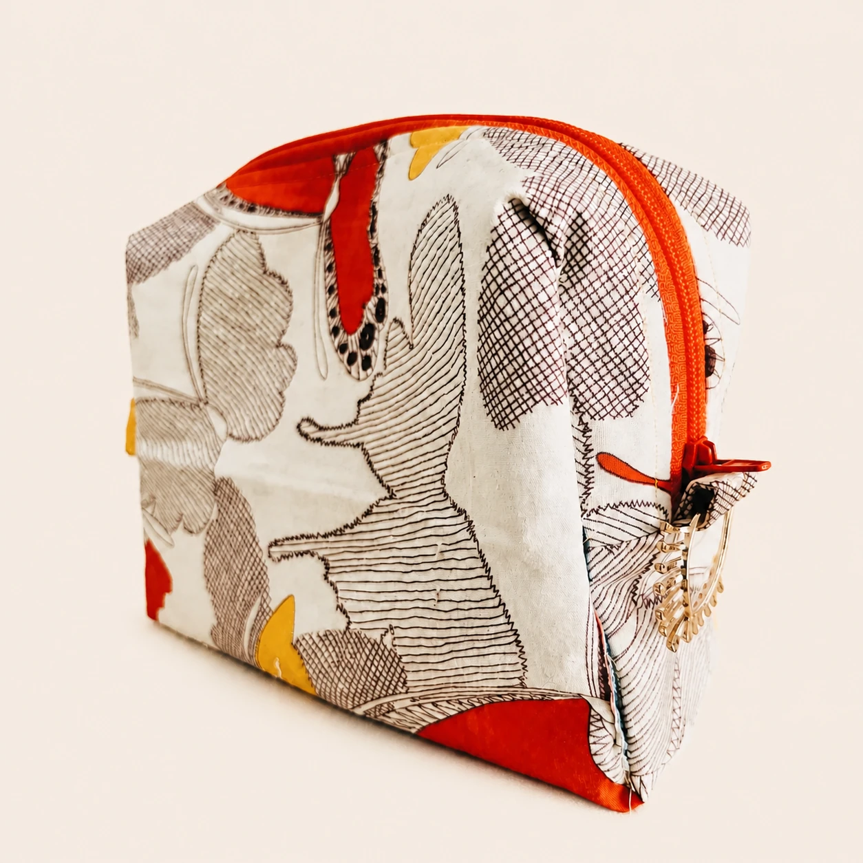 Side detail of the Butterfly Pouch showing its orange zipper and gold-tone hardware.