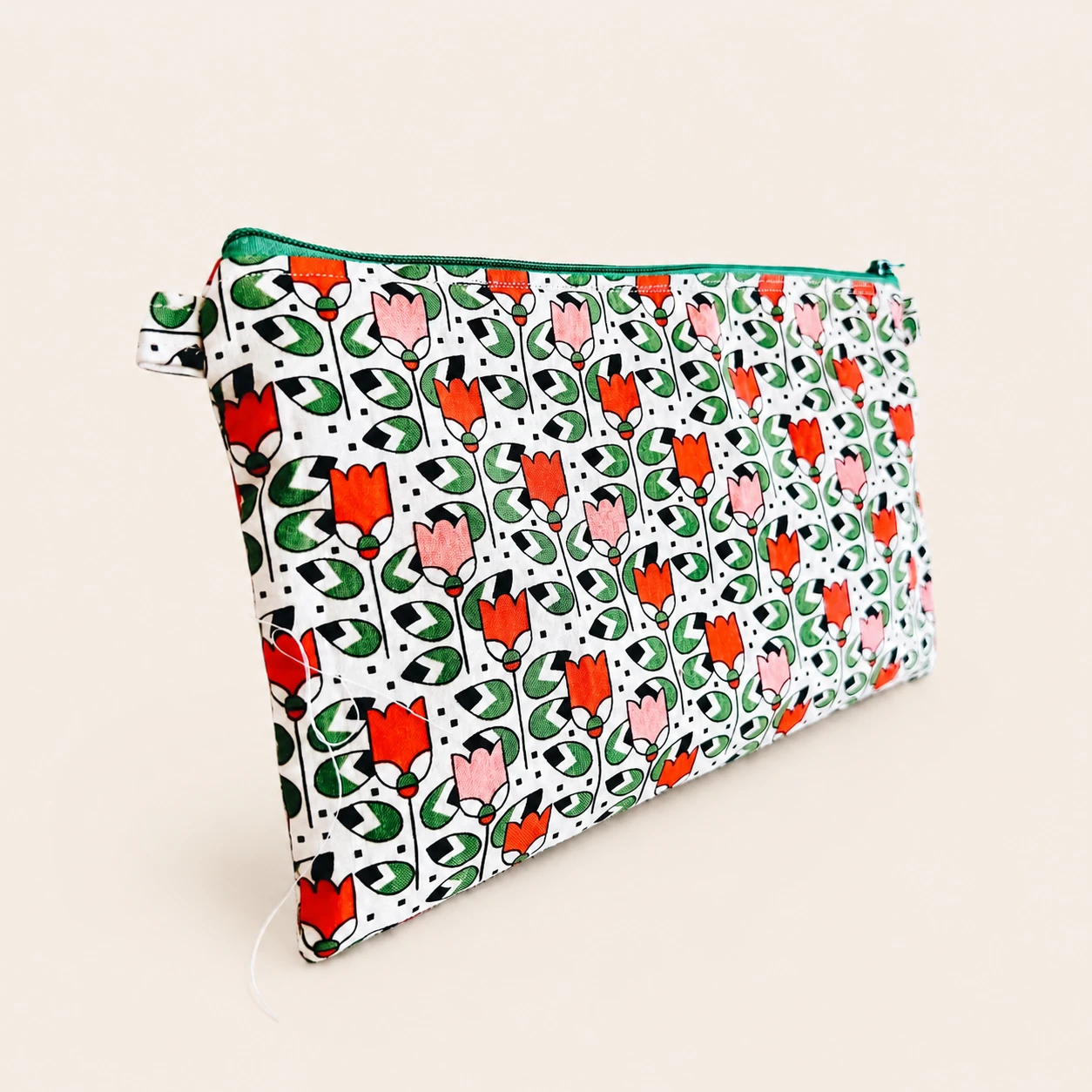 Front view of the Floral Cotton Pouch in orange, pink, green, black and white printed cotton.