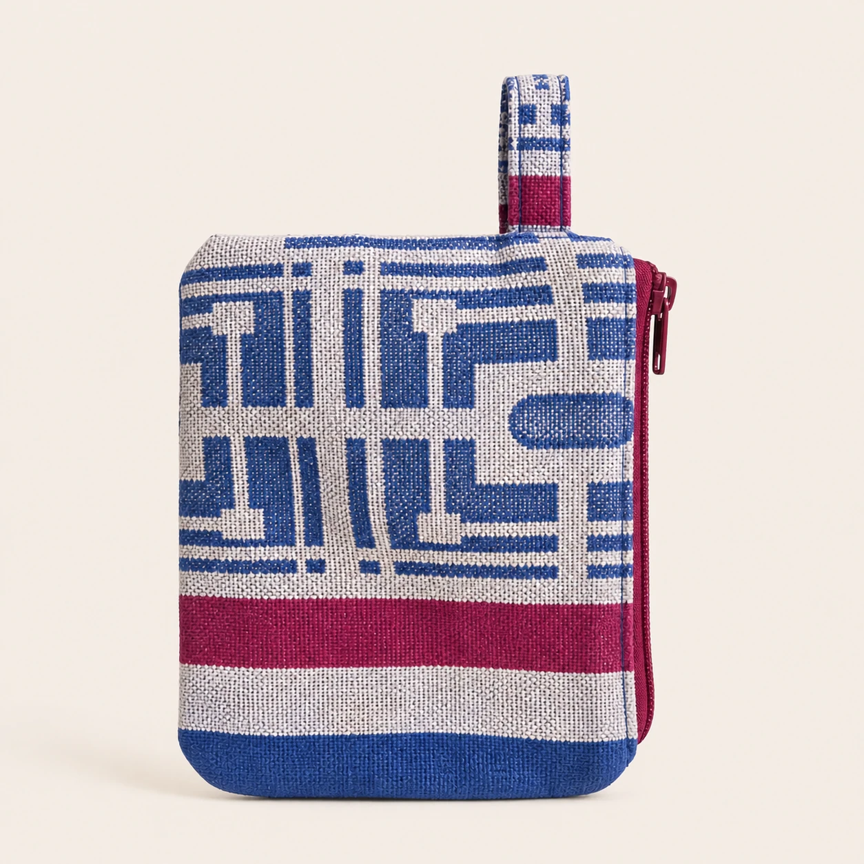 Side view of a small blue, cream and burgundy wallet with a red zipper and side tab.