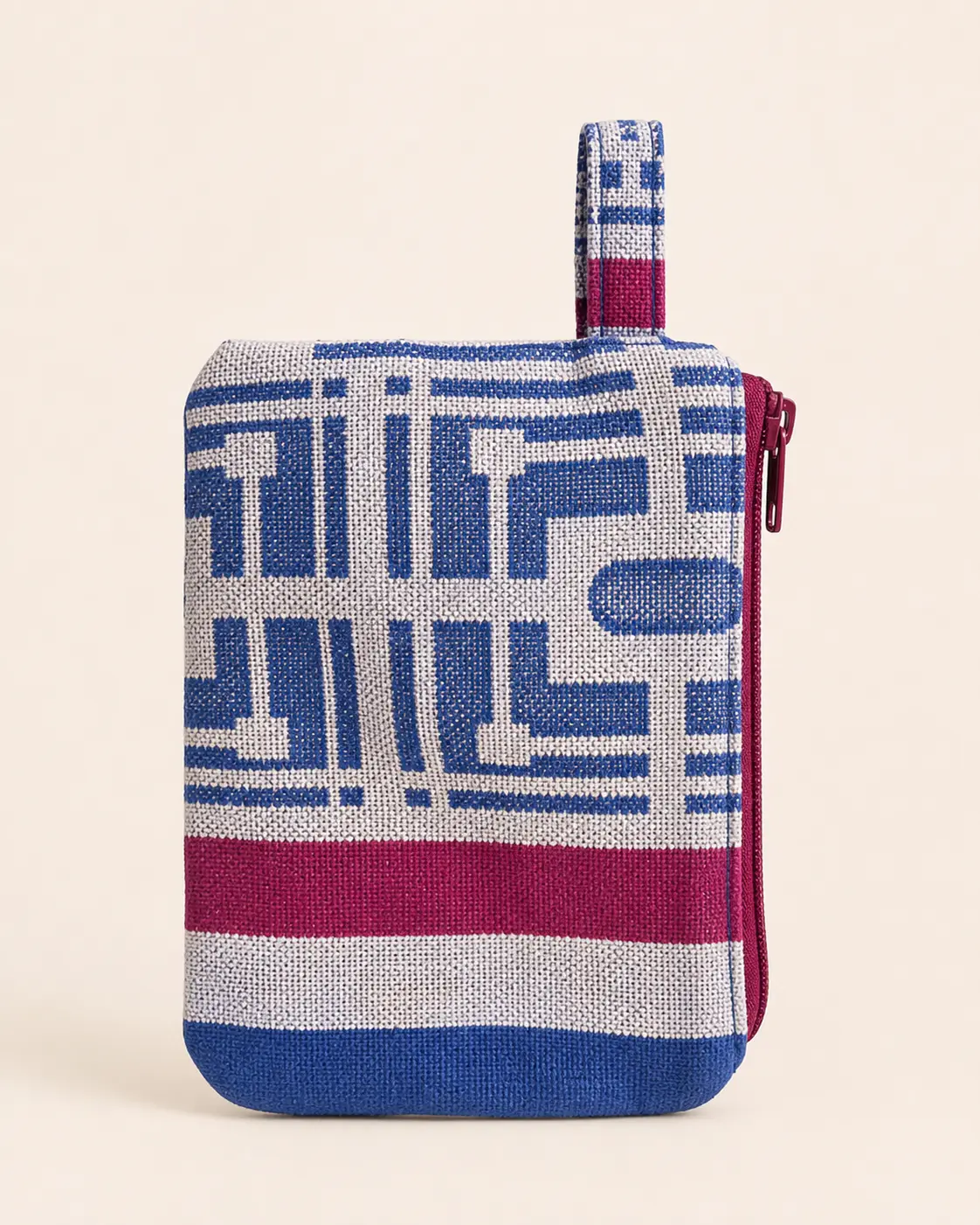 Side view of a small blue, cream and burgundy wallet with a red zipper and side tab.