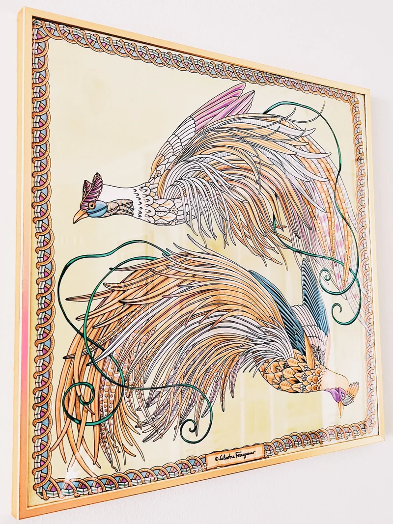 Two vintage Ferragamo silk cushion panels hand-sewn to mat board and displayed together in a slim yellow frame