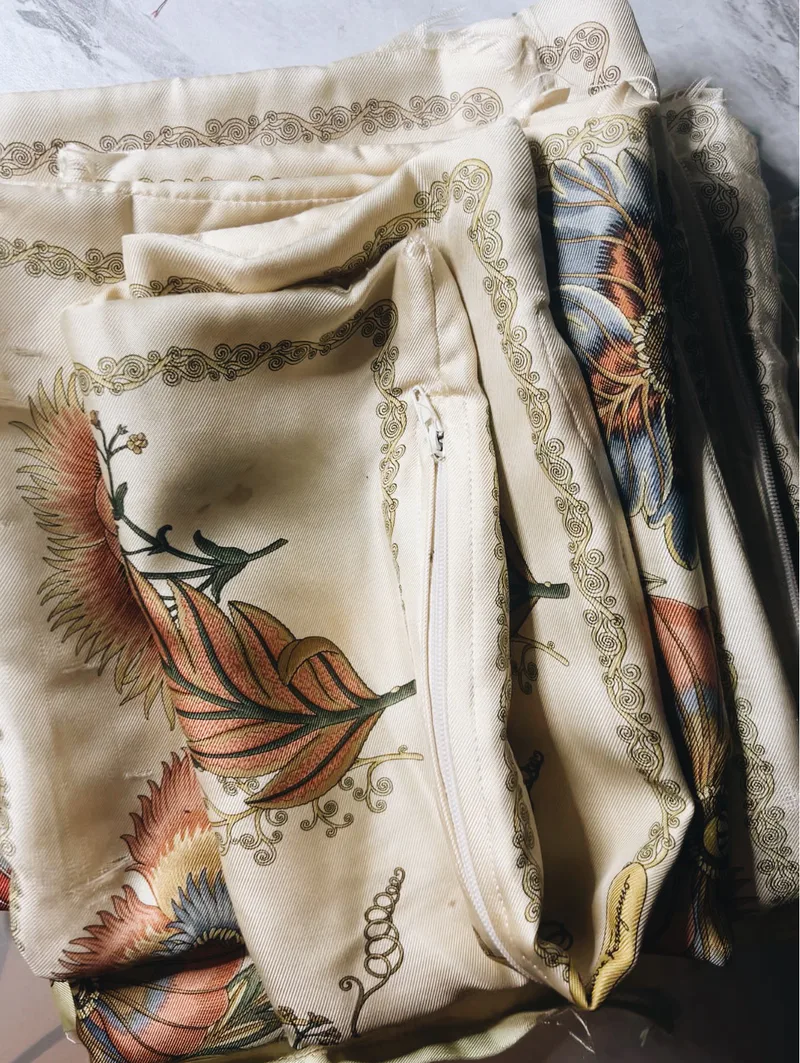 Vintage Ferragamo silk pillow covers with botanical motifs gathered before framing