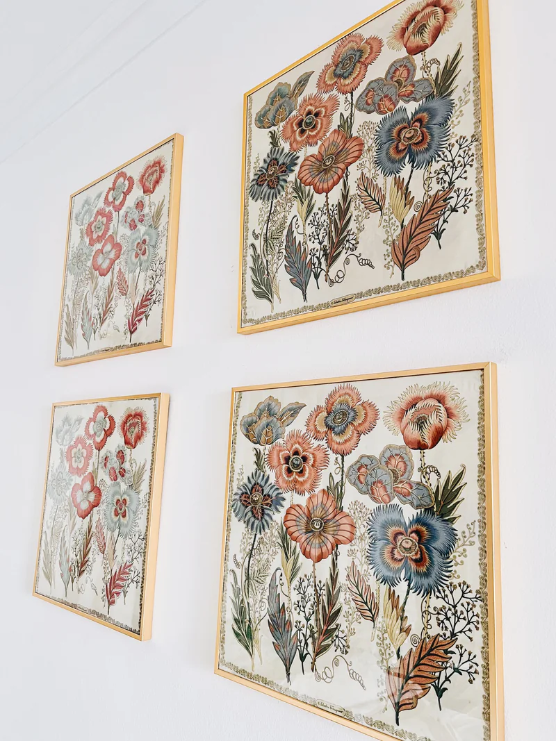 Four rescued vintage Ferragamo silk panels displayed in slim gold frames on a white wall